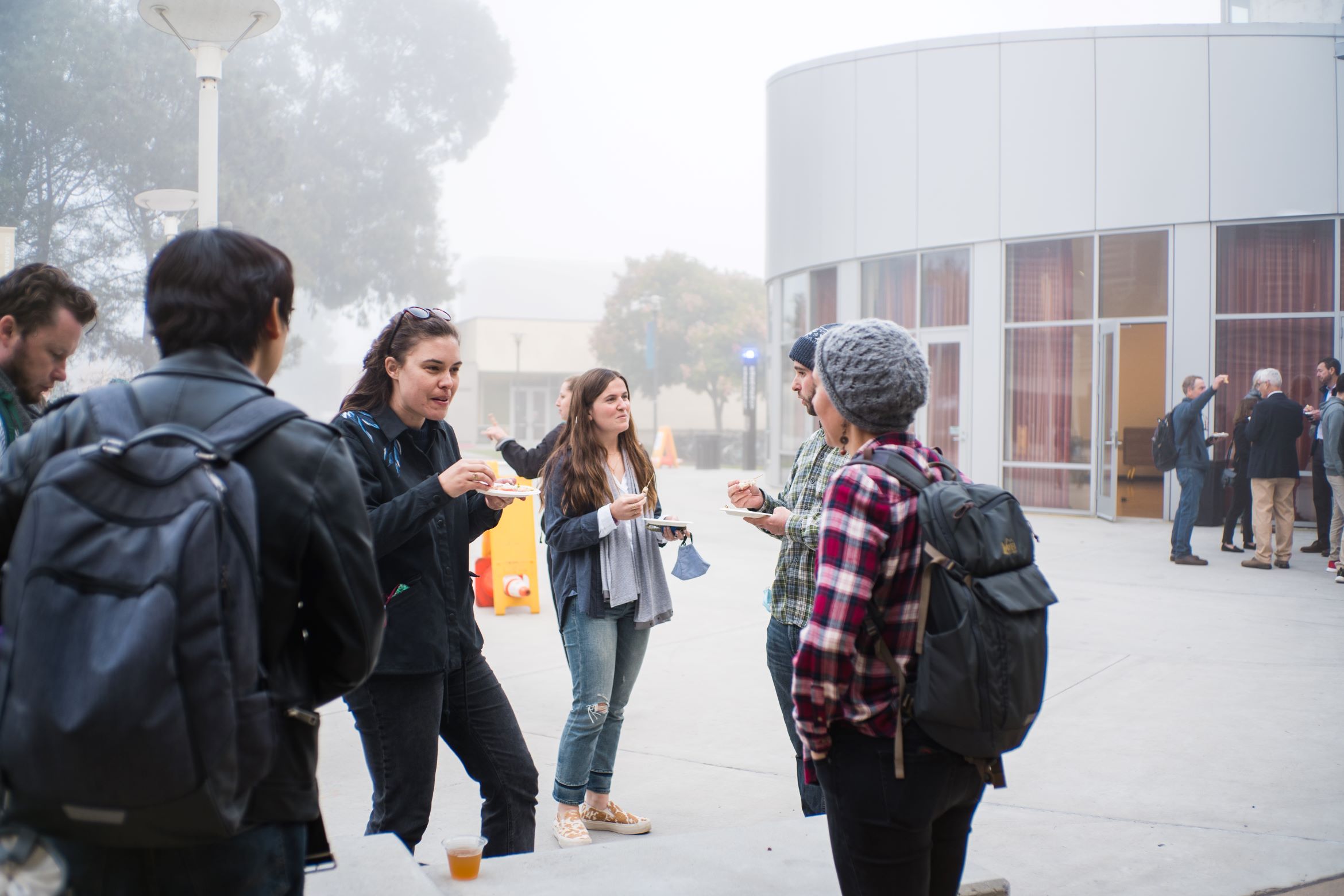 Students outside chatting during a wildfire lecture