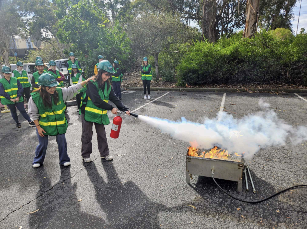 CERT trainee putting out fire with extinguisher